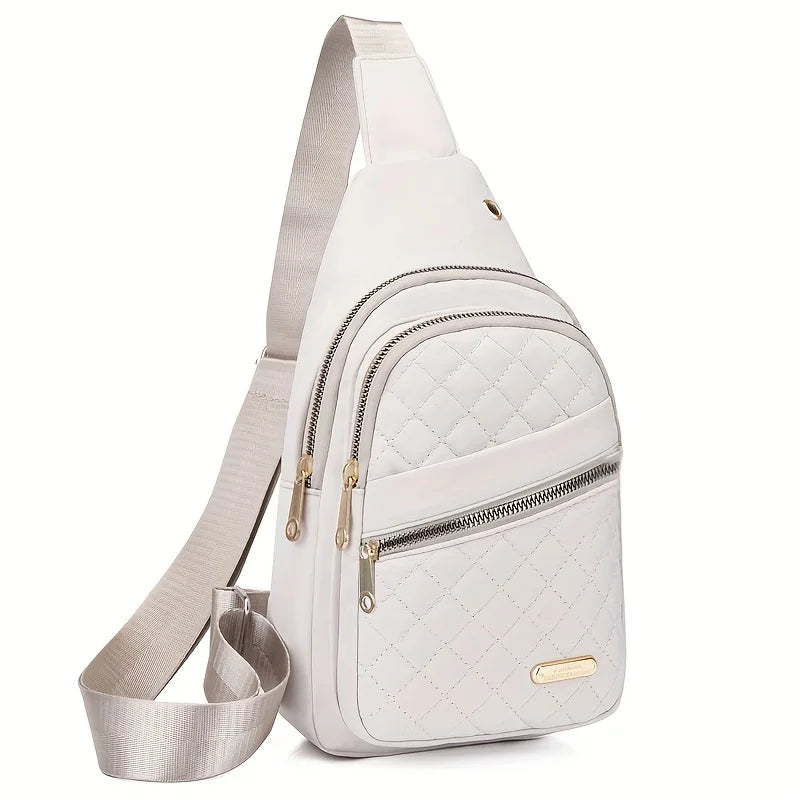 A light beige quilted crossbody sling bag with a silver zipper and matching strap.