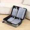 A gray travel compression packing cube set with a black case is shown open on a light-colored surface.