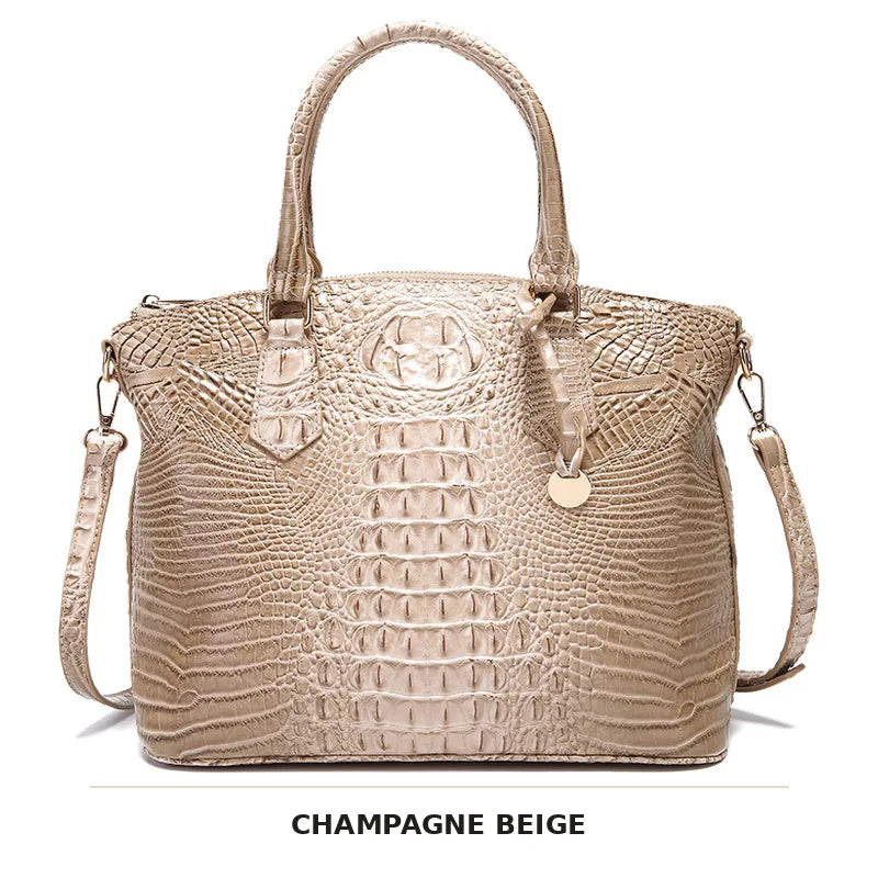 Beige krokod 신고muster Top Handtasche mit Crossbody-Gurt.