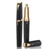 A black and gold precision electric eyebrow trimmer with a metallic tip is shown against a white background.