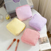 A collection of multi-functional storage pouches in various colors and striped patterns, including pink, yellow, purple, and 