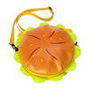 An orange cheeseburger shaped novelty backpack with a yellow strap and green accents.