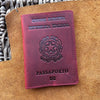 A maroon leather passport holder for the European Republic of Italy with embossed text and a national emblem.