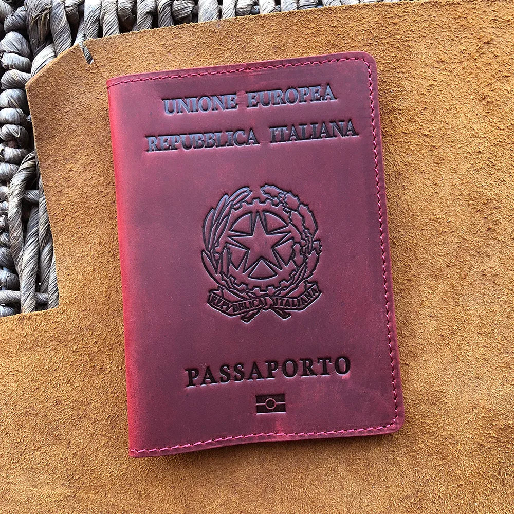 A maroon leather passport holder for the European Republic of Italy with embossed text and a national emblem.