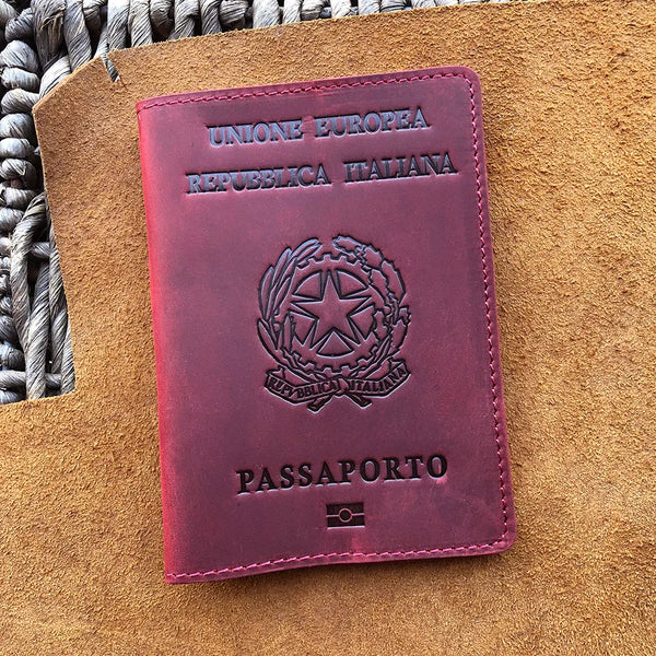 A maroon leather passport holder for the European Republic of Italy with embossed text and a national emblem.