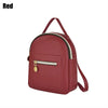 A maroon waterproof PU mini backpack with a zippered pocket and adjustable straps.