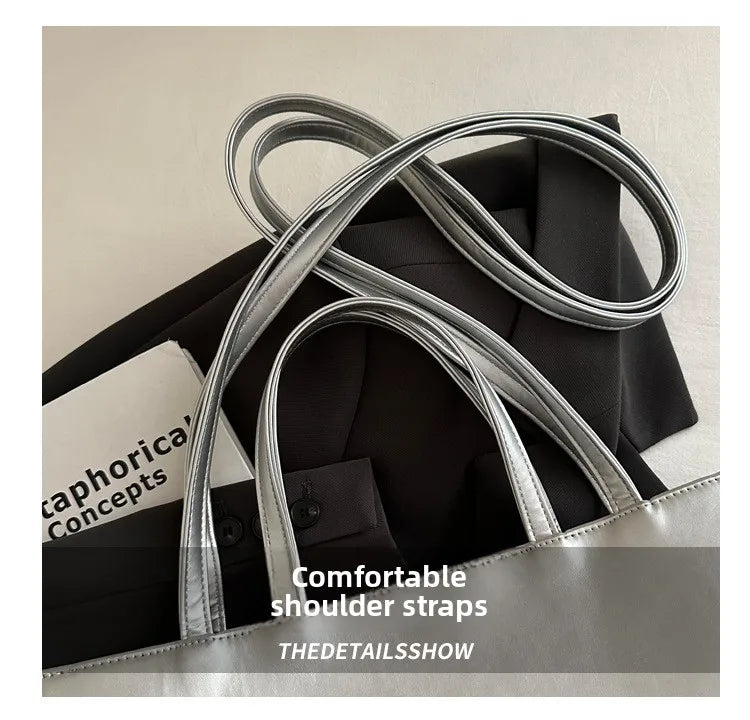Silver leather shoulder straps displayed on a black bag in a product show context.