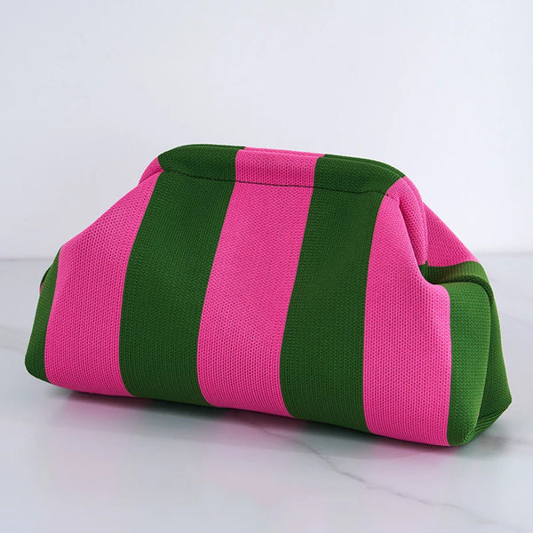 A woven striped crochet clutch bag featuring vertical stripes of pink and green.