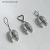 Silver metal angel wing keychain charm with a heart and star design