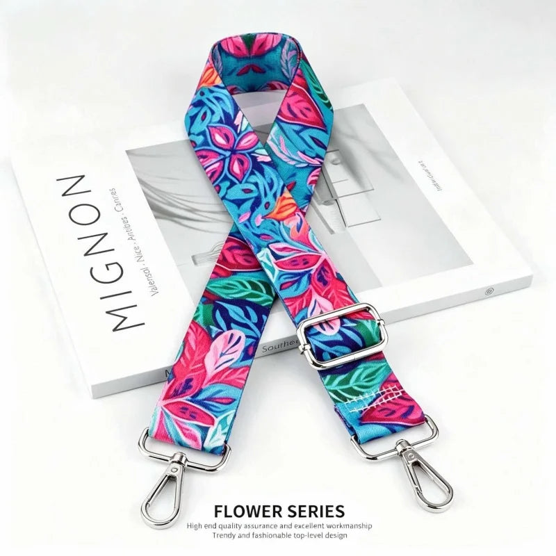 A vibrant floral patterned fabric strap is displayed next to a white box.