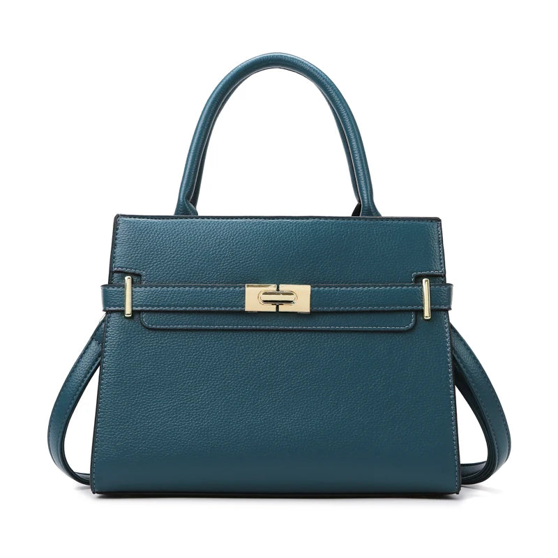 A dark teal leather handbag with gold hardware and a curved handle.