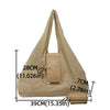 A beige nylon mini keychain tote bag shown with its strap and attached leather pouch.