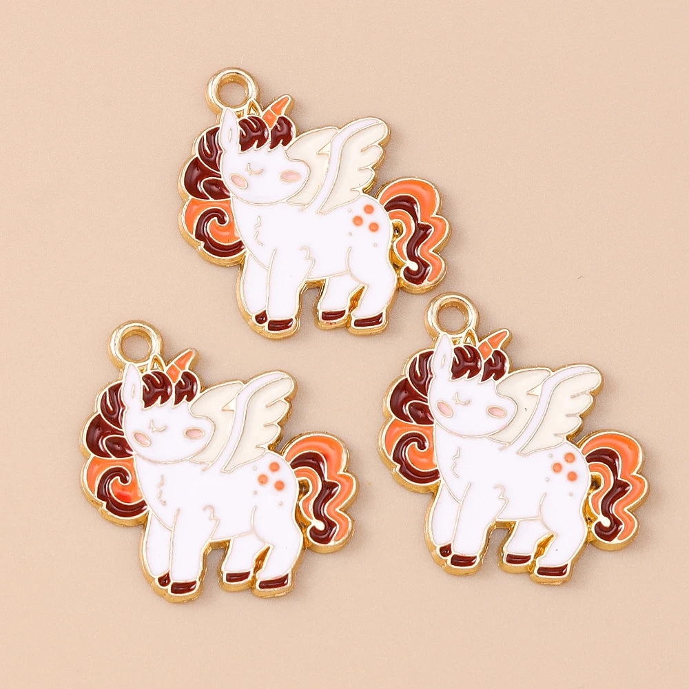 Two gold-colored charm pendants shaped like white unicorn horses with orange and brown accents.