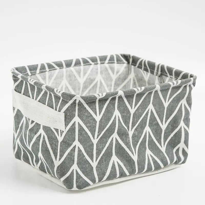 A gray and white patterned storage basket made of waterproof cotton linen for desk organization.