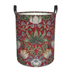 A vintage floral laundry hamper with a red background featuring green and blue foliage patterns.