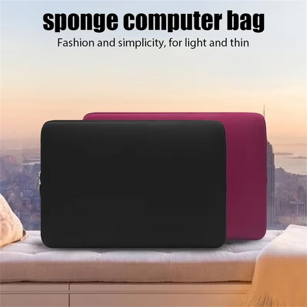 A black laptop is placed inside a pink sponge computer bag on a light surface.