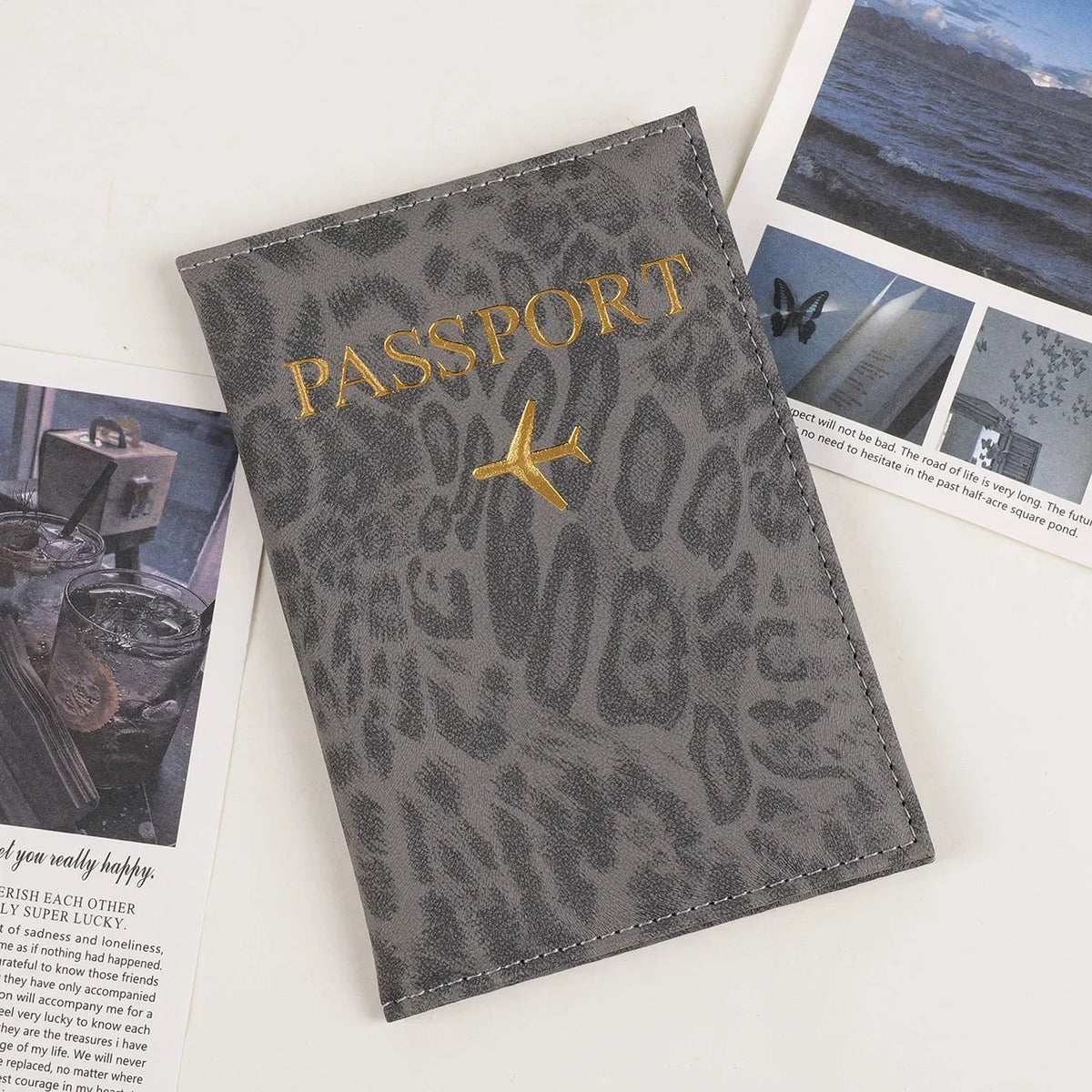 A grey leopard print PU leather passport holder with gold lettering and a passport photo visible.
