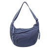A navy blue canvas crossbody shoulder bag with a long strap.