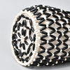 A close-up of an elegant beaded clutch bag featuring black and white seed beads.