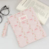 Pink and white striped cotton tablet pouch with floral embroidery and a secure closure