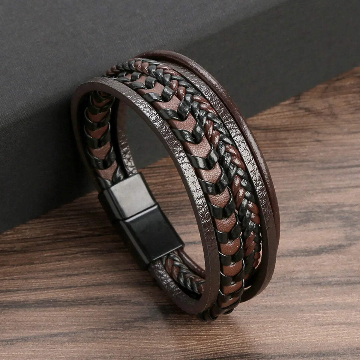 A dark brown leather bracelet featuring a multi-layer braided design with tiger eye beads.
