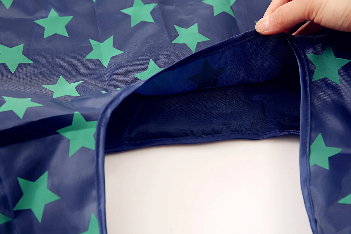 A dark blue reusable shopping bag with green stars, showing the interior fold.