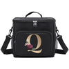Black insulated canvas lunch bag with dual handles featuring a gold letter Q and a small floral accent.