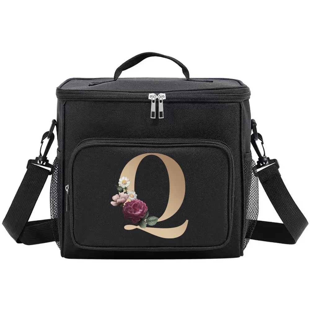 Black insulated canvas lunch bag with dual handles featuring a gold letter Q and a small floral accent.