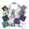 A collection of colorful floral print fabric squares and pouches for grocery and storage.