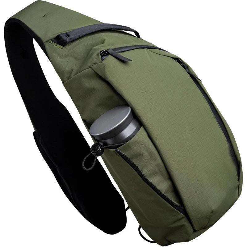 Olive green crossbody sling bag designed to carry a tablet and water bottle.