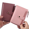 A pink leather wallet with a card holder and coin pocket is shown being held by a hand.