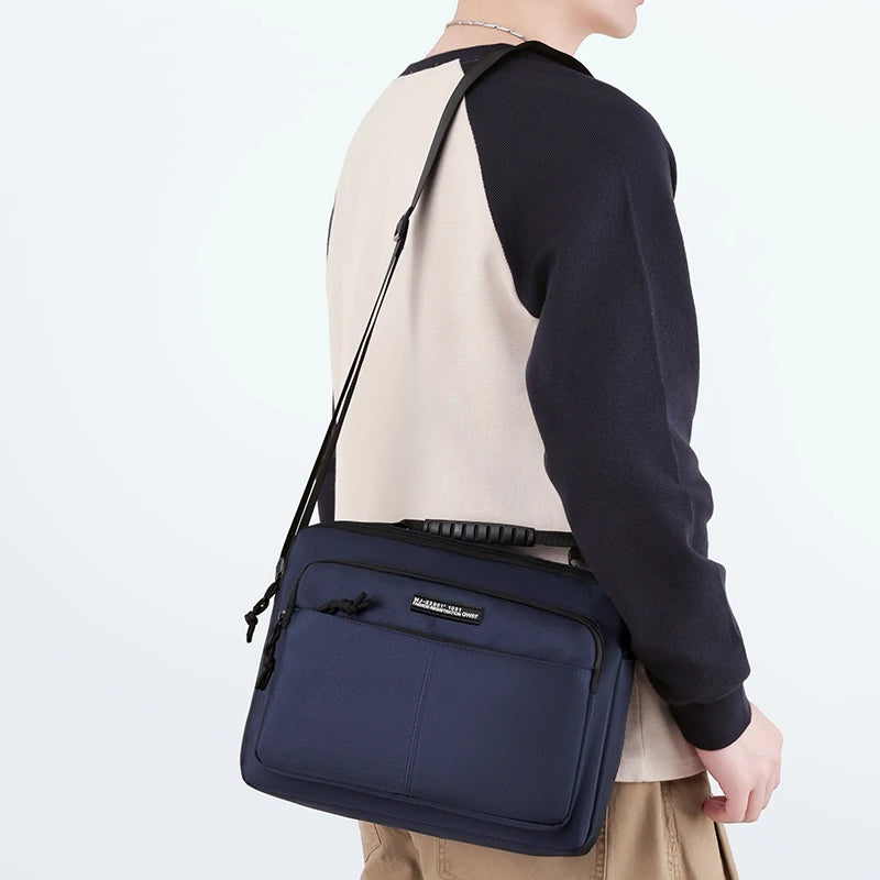 A navy blue professional waterproof men's business briefcase worn over a light colored shirt.