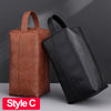 A brown leather toiletry bag and a black leather travel bag are shown side by side.