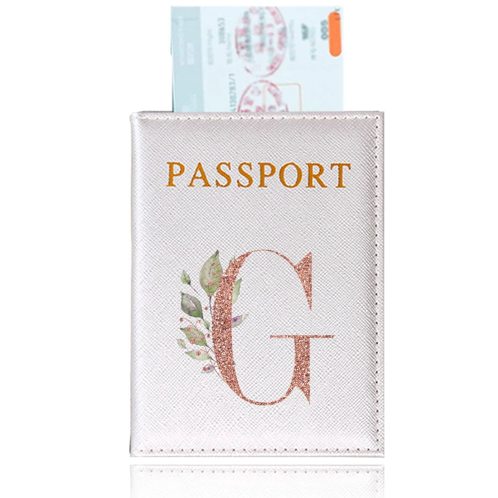 A light pink elegant PU travel passport holder featuring a gold initial G and green foliage design.