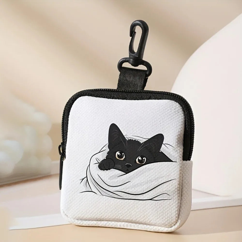 A black cat illustration on a white fabric coin purse with a black hook closure.