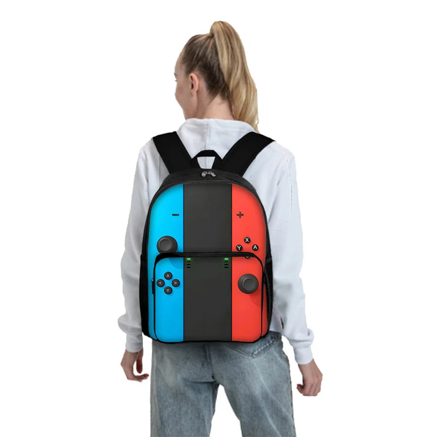 A black and red GamePad cartoon backpack for kids with a front pocket worn by a person.