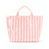 A pink and cream striped tote bag with a handle, featuring white paint splatters.
