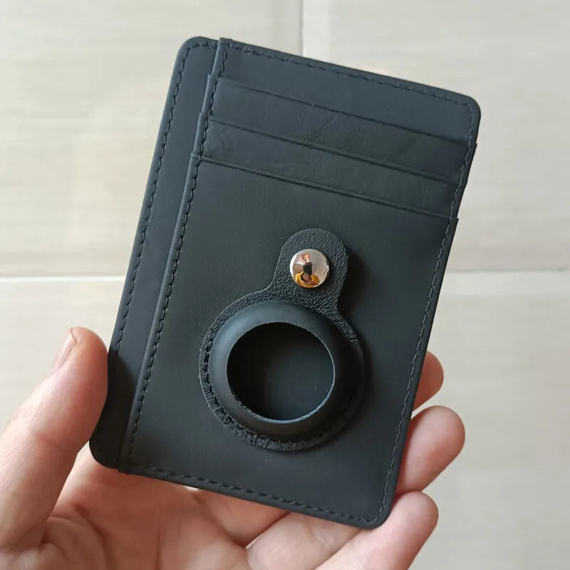 A black leather RFID blocking card holder wallet is held in a hand.