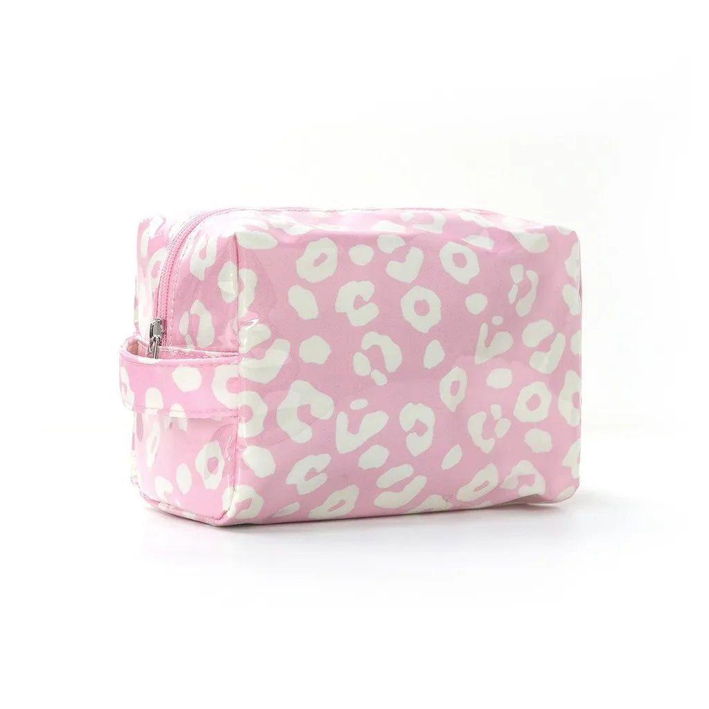 A pink leopard print waterproof travel cosmetic bag lying flat on a white background.
