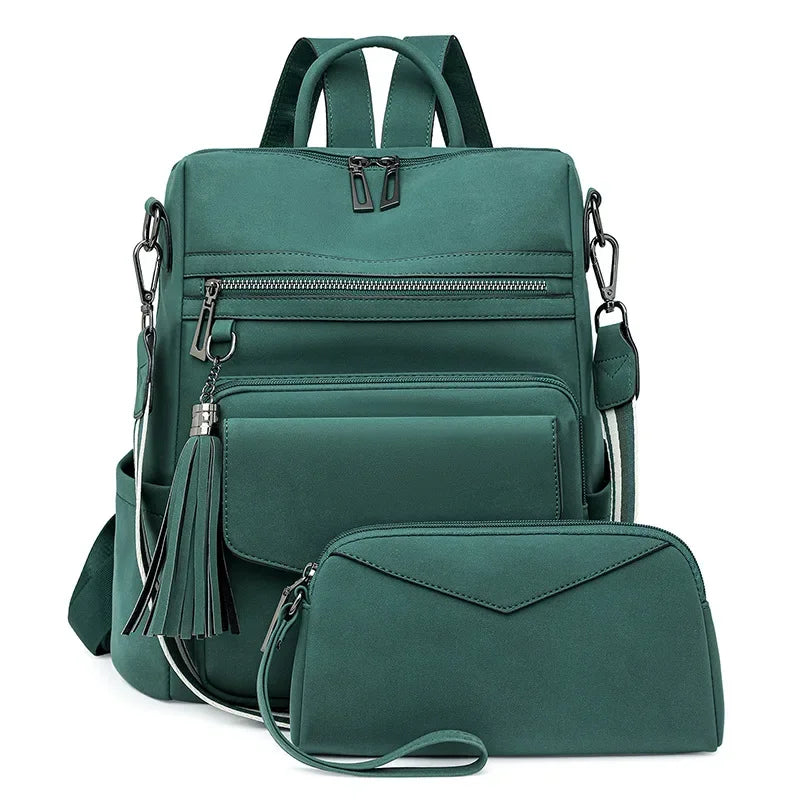 A dark teal retro PU leather travel backpack with a tassel detail shown in a studio shot.