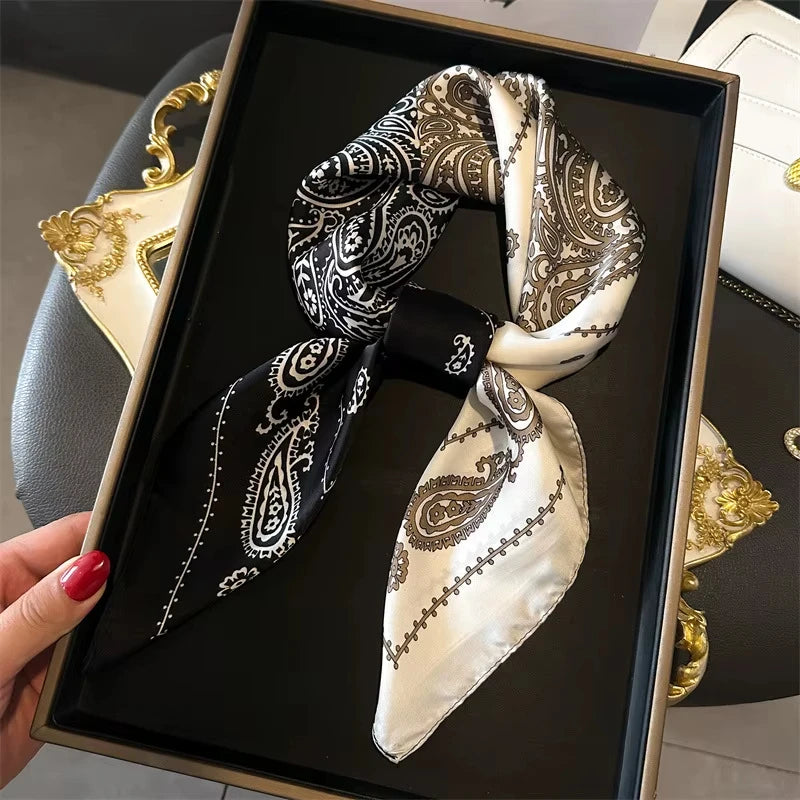 Elegant paisley silk hair scarf and headband in black and cream patterns displayed in a gold box.