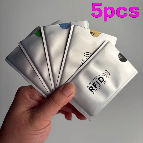 A hand holds five geometric RFID blocking card sleeves, showing the protective design and branding.