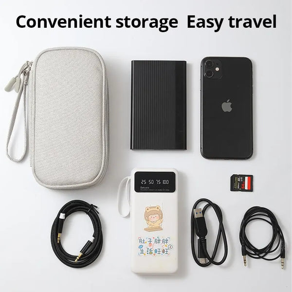 A collection of portable digital accessories including a storage pouch, a smartphone, and charging cables is displayed on a w