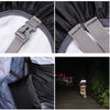 Close-up of a gray strap and black rain cover material for an outdoor camping backpack.