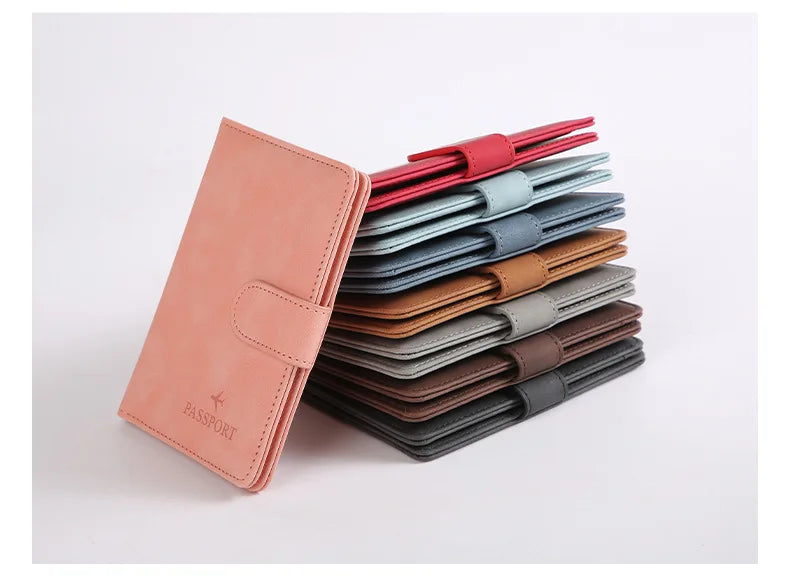 Une pile de porte-passeports et de portefeuilles pour cartes de crédit en cuir imperméable, dans diverses nuances de rouge, b