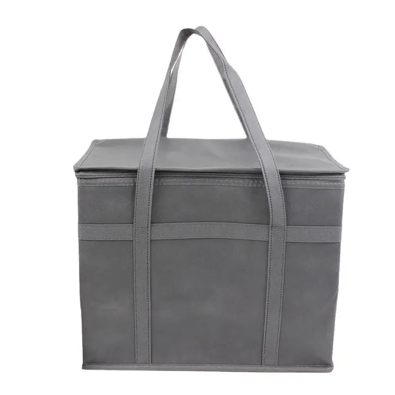 A gray foldable insulated grocery and food cooler bag with handles.