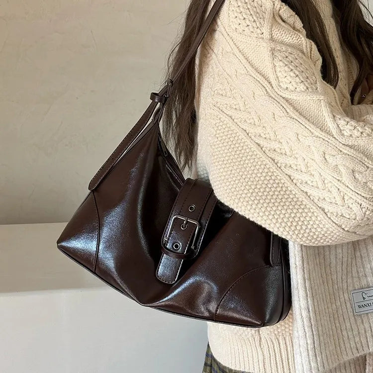 A brown retro PU leather underarm bag with a strap is shown against a light background.