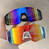 A hand holds a pair of lightweight oversized sunglasses with vibrant iridescent lenses.