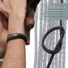 A close-up of a black braided leather cord used for jewelry making, shown next to a person's wrist.