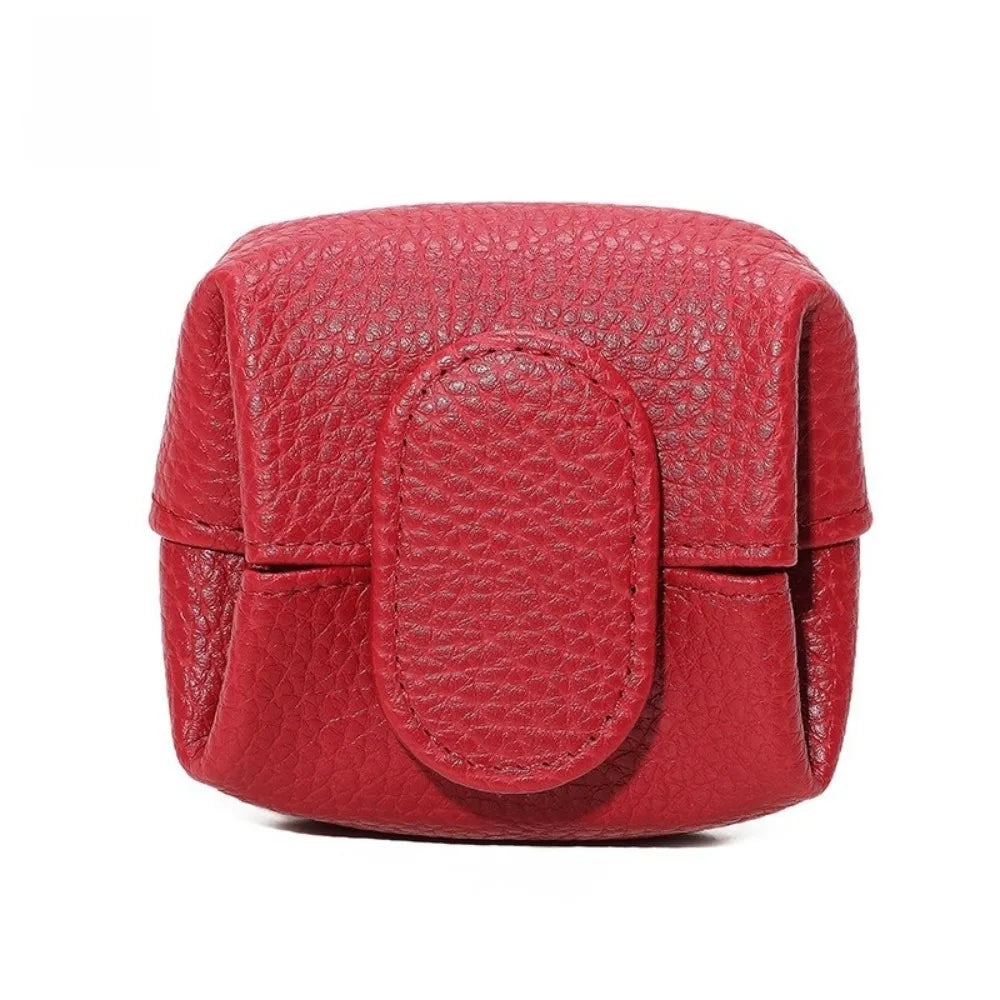 A compact red lychee-textured coin purse with a snap closure.